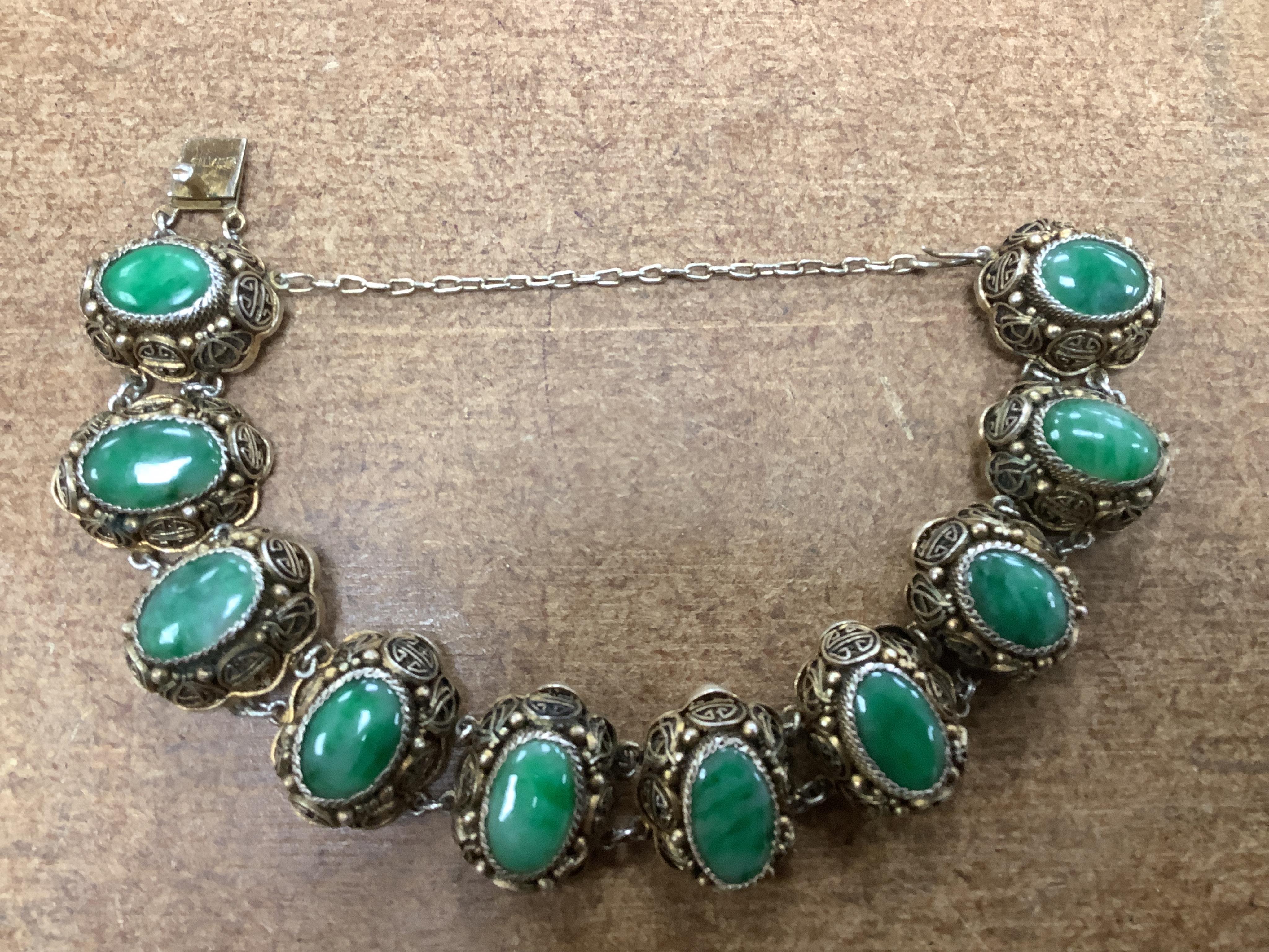 Sixteen Chinese jade and hardstone carvings, including a gilded white metal and jadeite bracelet, three pendants etc. Condition - fair